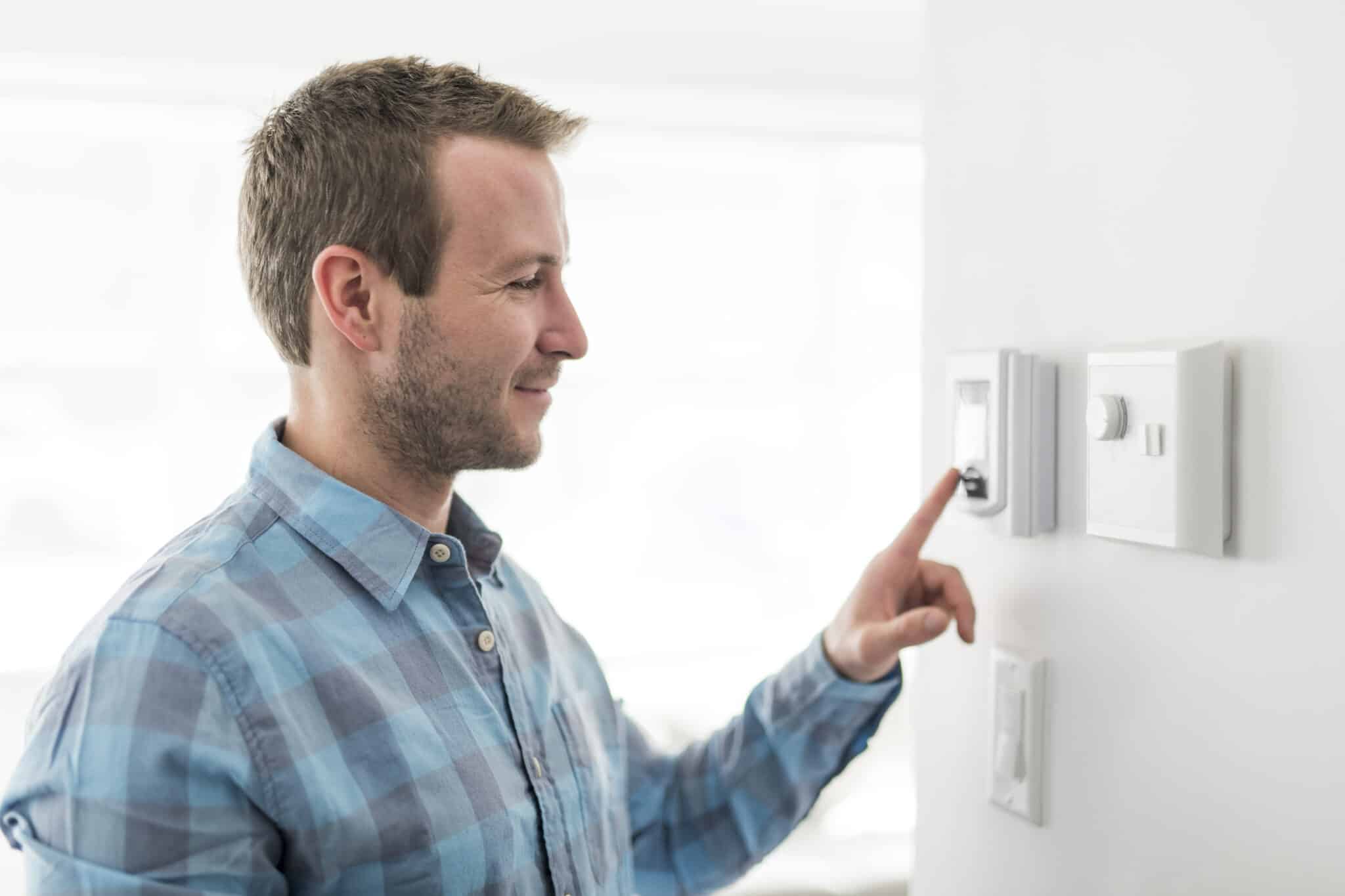 A man set the thermostat at home, Humidity Management.