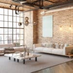 A modern loft living room featuring a couch, a coffee table, and efficient HVAC solutions.